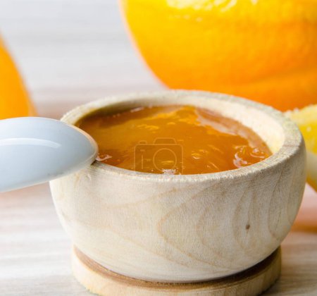 Photo for The orange jam served in spoon on the table - Royalty Free Image