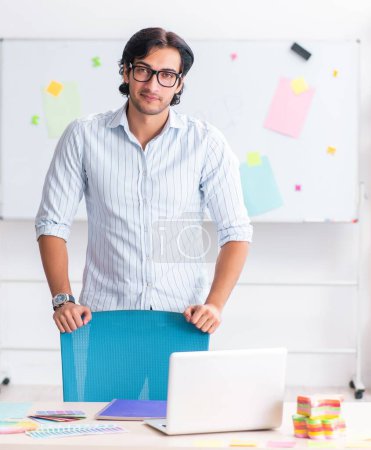 Photo for The young handsome male designer working in the office - Royalty Free Image