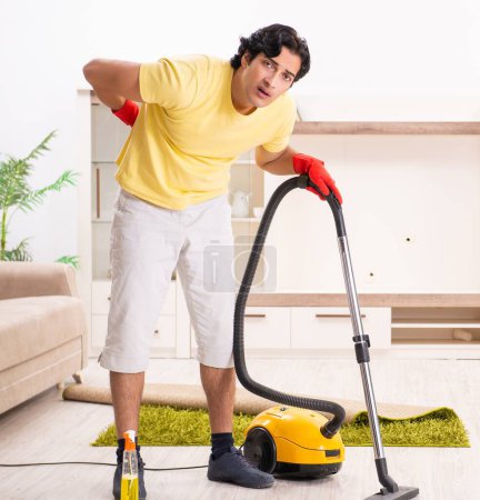 Photo for The young handsome man doing housework - Royalty Free Image