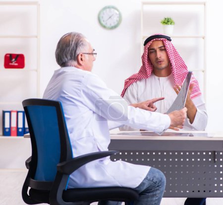 Photo for The young male arab visiting experienced male doctor - Royalty Free Image
