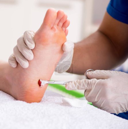 Photo for The podiatrist treating feet during procedure - Royalty Free Image