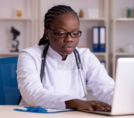 Photo for The black female doctor working at clinic - Royalty Free Image