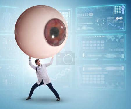 Foto de El médico examinando el ojo gigante en concepto médico - Imagen libre de derechos