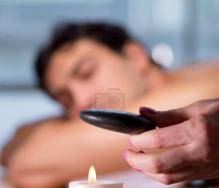 Photo for The young handsome man during spa procedure - Royalty Free Image