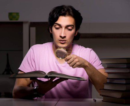 Photo for The male handsome student preparing for exams late at home - Royalty Free Image