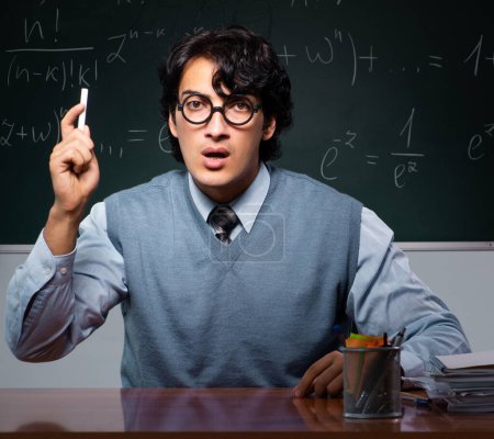 Photo for The young math teacher in front of chalkboard - Royalty Free Image