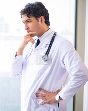 Photo for The young handsome doctor standing at the window - Royalty Free Image