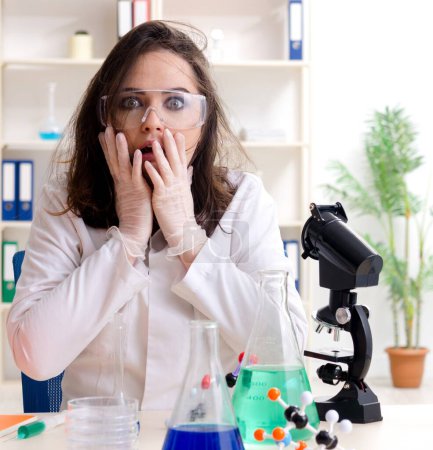Photo for The funny female chemist working in the lab - Royalty Free Image