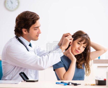 Photo for Patient with hearing problem visiting doctor otorhinolaryngologist - Royalty Free Image