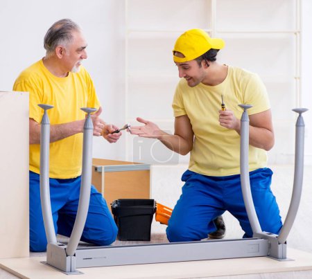 Photo for The two contractors carpenters working indoors - Royalty Free Image