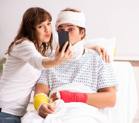 Photo for The loving wife looking after injured husband - Royalty Free Image