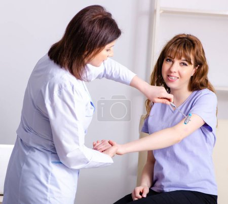 Photo for The young woman visiting female doctor physiotherapist - Royalty Free Image
