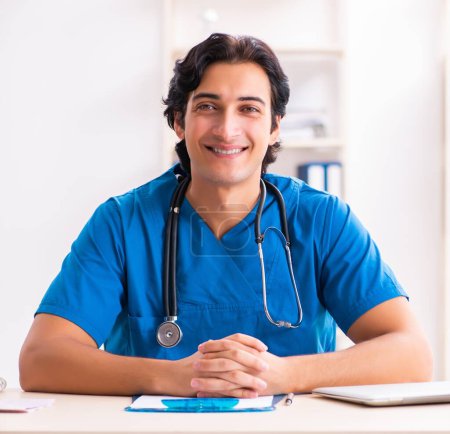 Photo for The young handsome doctor working at the clinic - Royalty Free Image