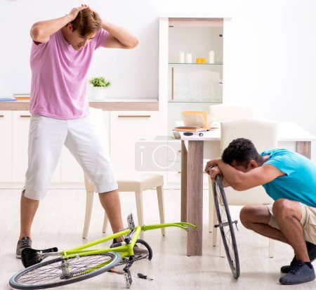 Photo for The man repairing his broken bicycle - Royalty Free Image
