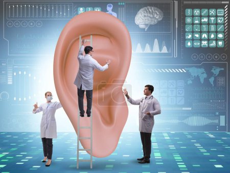 Foto de El médico examinando el oído gigante en concepto médico - Imagen libre de derechos