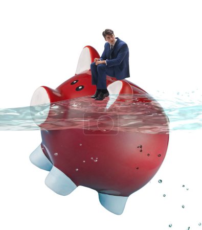 Foto de El hombre de negocios en concepto de deuda con Piggybank - Imagen libre de derechos