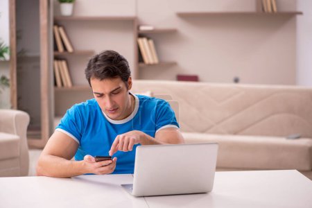 Photo for Young male freelancer working from home - Royalty Free Image