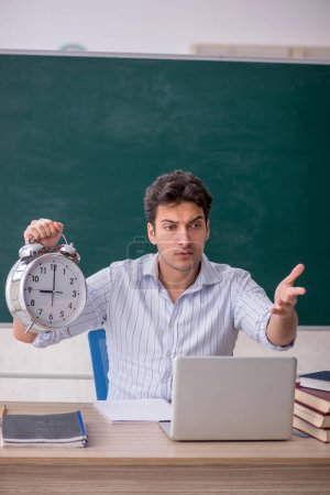 Photo for Young teacher in time management concept - Royalty Free Image