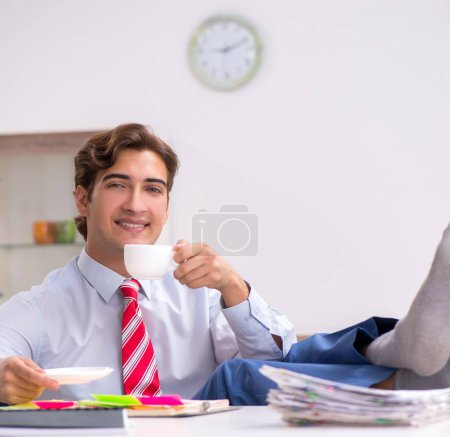 Photo for The young attractive businessman working in the office - Royalty Free Image