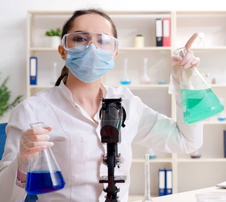 Photo for The young female chemist working in the lab - Royalty Free Image