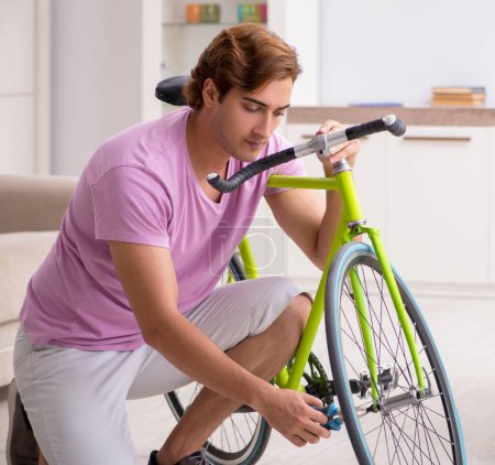 Photo for The man repairing his broken bicycle - Royalty Free Image