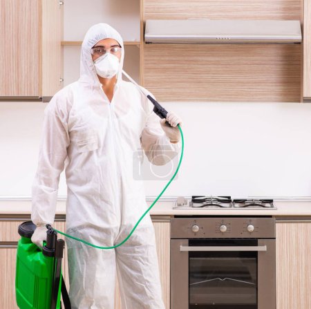 Photo for The professional contractor doing pest control at kitchen - Royalty Free Image
