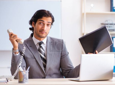 Photo for The young handsome businessman employee in the office - Royalty Free Image
