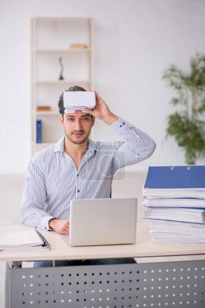 Photo for Young employee enjoying virtual glasses in the office - Royalty Free Image