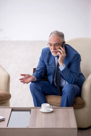 Photo for Old male boss waiting for business meeting - Royalty Free Image