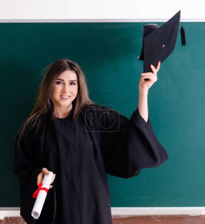 Photo for The female graduate student in front of green board - Royalty Free Image