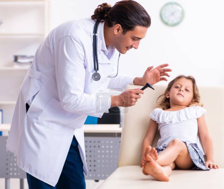 Photo for The young doctor pediatrician with small girl - Royalty Free Image