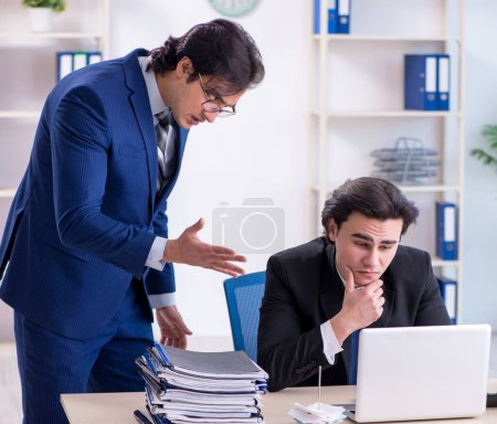 Photo for The boss and his male assistant working in the office - Royalty Free Image