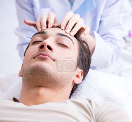 Photo for The young handsome man visiting female doctor cosmetologist - Royalty Free Image