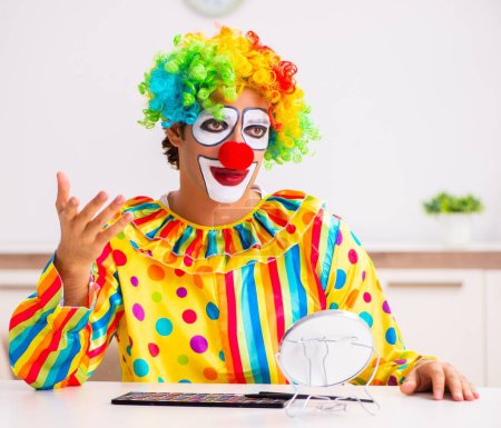Photo for The male clown preparing for perfomance at home - Royalty Free Image