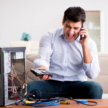 Photo for The angry customer trying to repair computer with phone support - Royalty Free Image