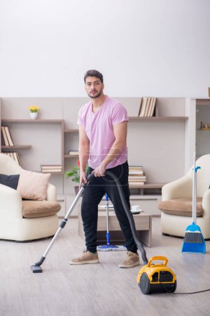 Photo for Young contractor cleaning the house - Royalty Free Image