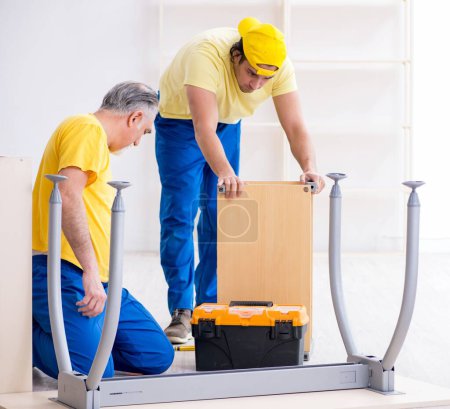 Photo for The two contractors carpenters working indoors - Royalty Free Image