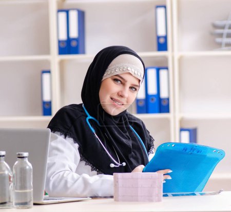 Photo for The young doctor in hijab working in the clinic - Royalty Free Image