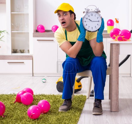Photo for The young male contractor doing housework after party - Royalty Free Image