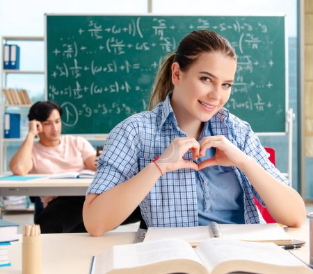 Photo for The young students taking the math exam in classroom - Royalty Free Image
