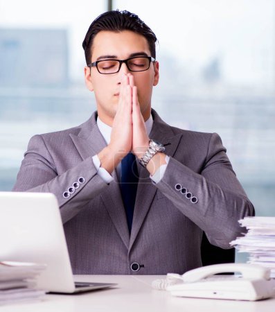 Photo for The businessman meditating in the office - Royalty Free Image