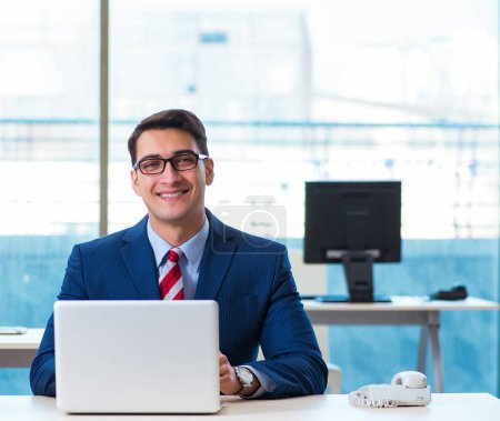 Photo for The young handsome businessman employee working in office at desk - Royalty Free Image