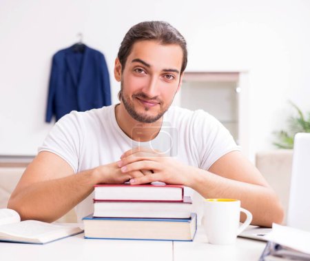 Photo for The young male student preparing for exams at home - Royalty Free Image