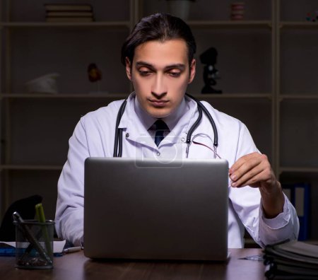 Photo for The young male doctor in the hospital at night - Royalty Free Image