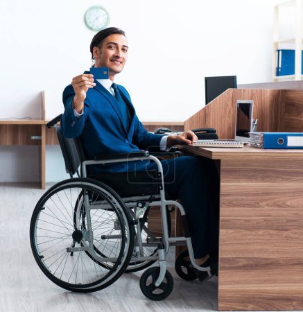 Photo for The young male employee in wheel-chair - Royalty Free Image