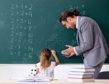 Photo for The teacher with young girl in the classroom - Royalty Free Image