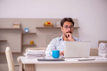 Photo for Young male employee working from home during pandemic - Royalty Free Image