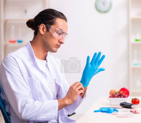 Photo for Young nutrition expert testing food products in lab - Royalty Free Image