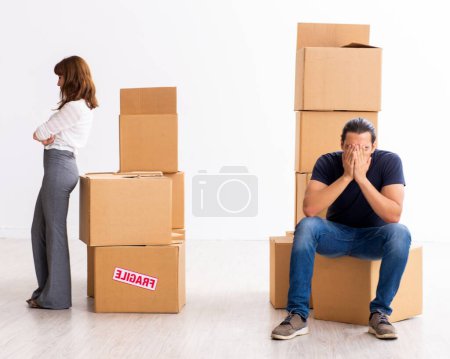 Photo for Young pair and many boxes in the divorce settlement concept - Royalty Free Image