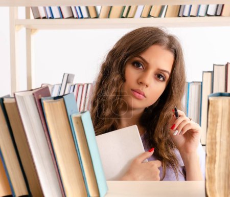 Photo for The young female student preparing for exams at library - Royalty Free Image